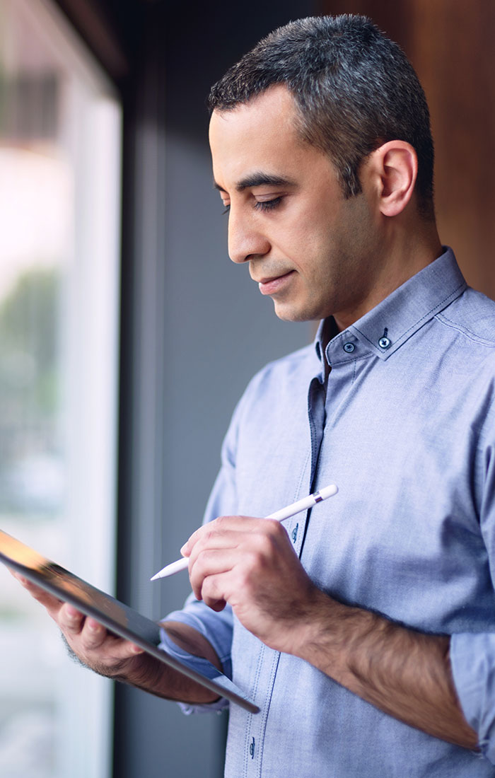 A talent agent writing on digital tablet using stylus.