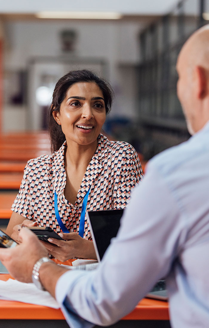 A teacher discussing work with her colleague.