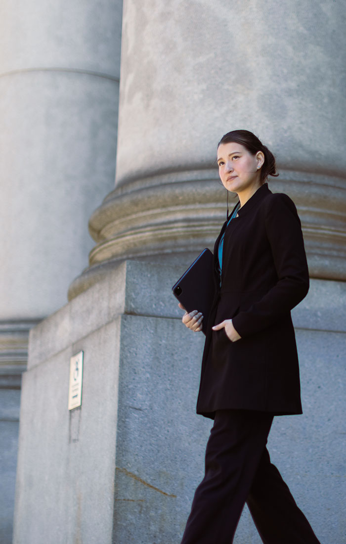 A woman in business attire is coming out of the administrative office