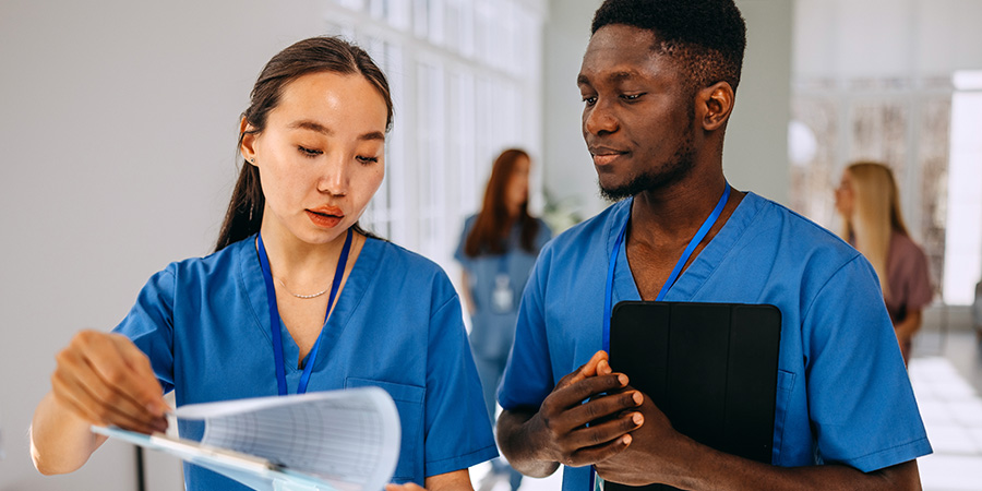 Nurses review a patient’s chart.