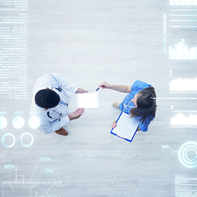 Two people discussing medical data