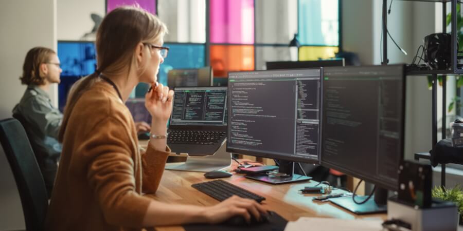 Data scientists work on computers in their office.