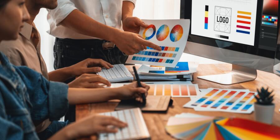 Members of a graphic design team work on a corporate logo