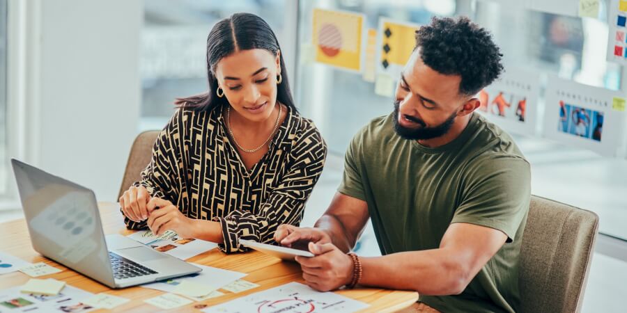 A brand strategist works with a member of the creative team on brand visuals.