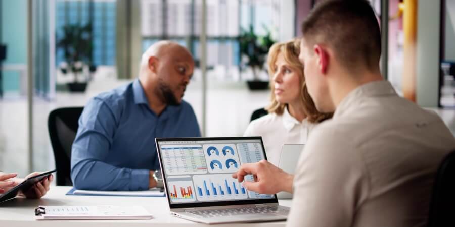A data analyst creates a data visualization dashboard on a laptop.