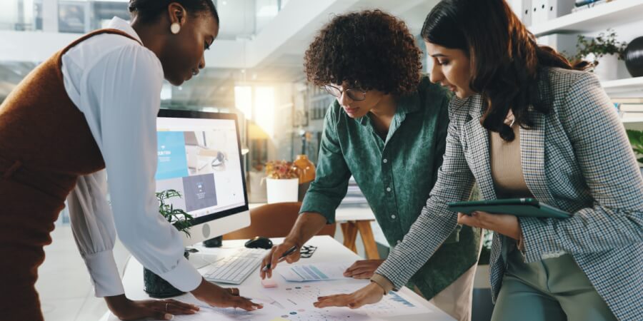 A website design lead reviews some concepts with two designers.