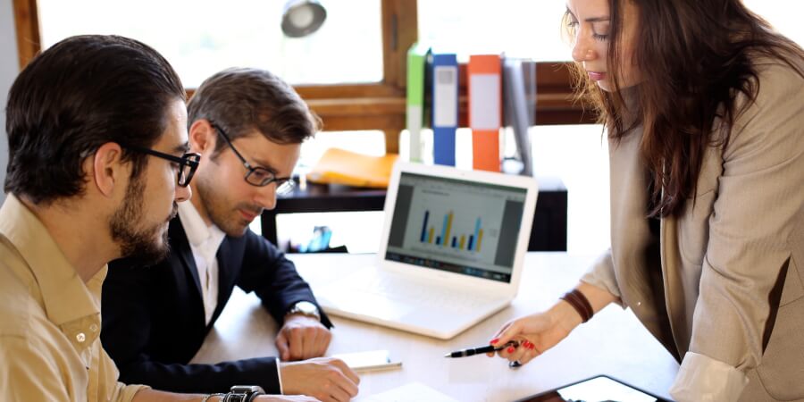 Members of a business intelligence team review data visualizations.