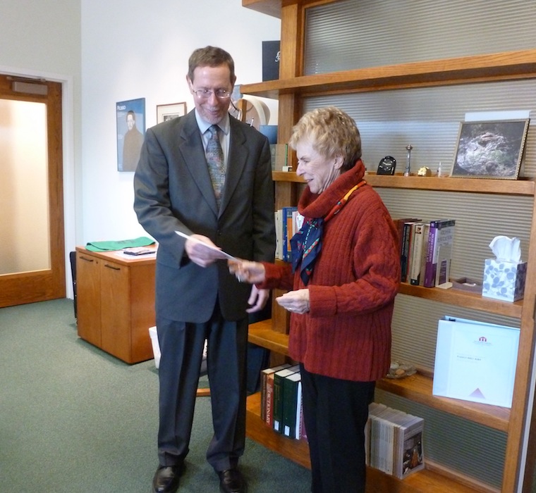 Oviatt Library dean Mark Stover accepts $4,500 check donation from SAGE president Jeanne Polak-Recht.