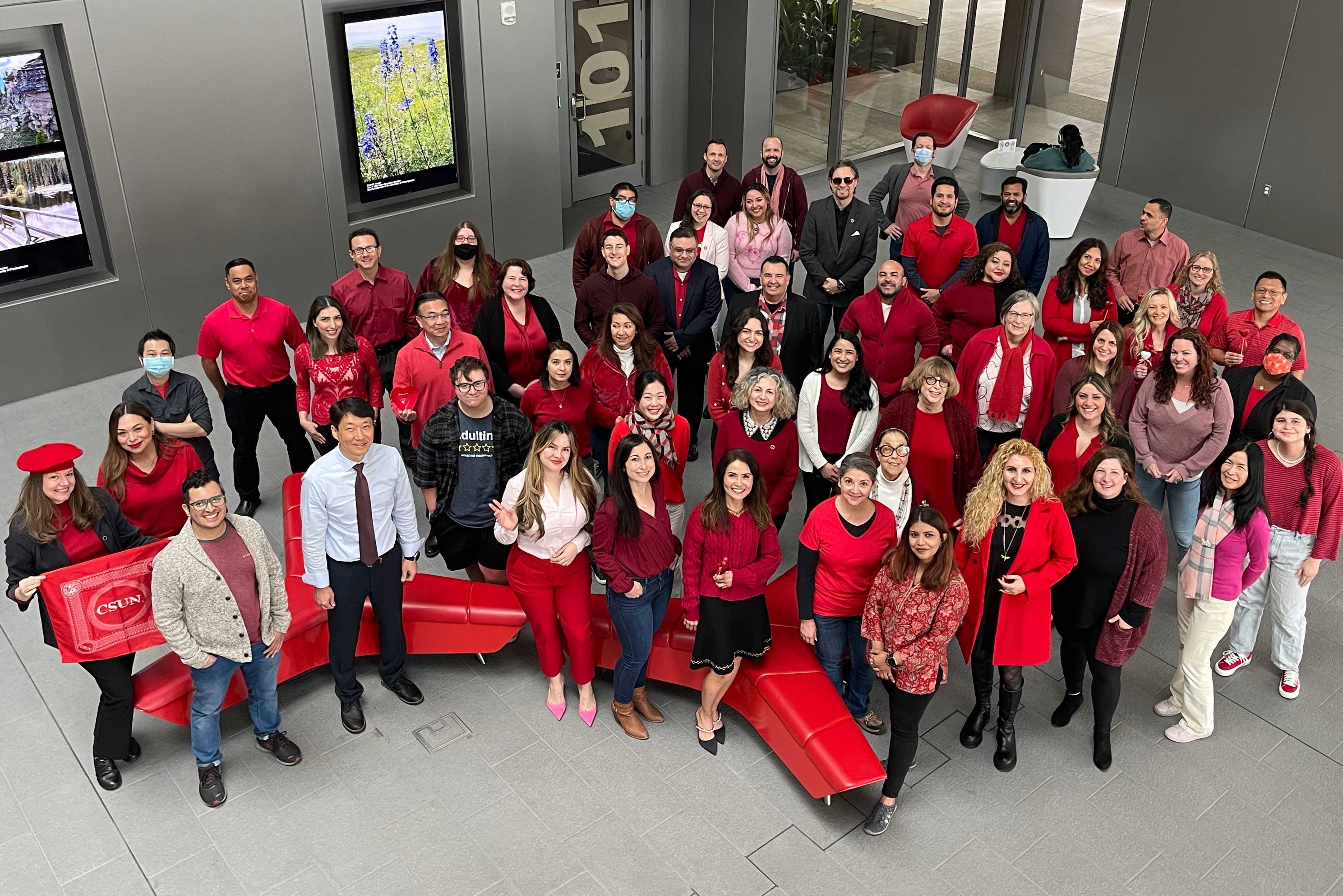 Tseng College staff wearing red standing for Valentines group photo