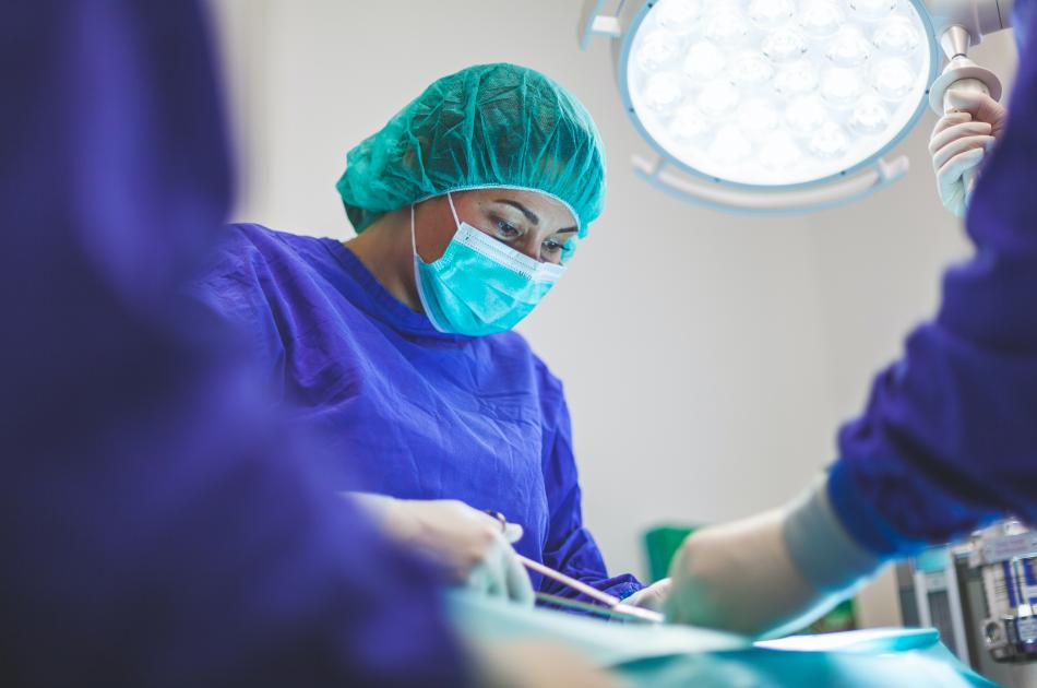 New Perioperative Nursing Program Doctor operating on patient with nurses' aid