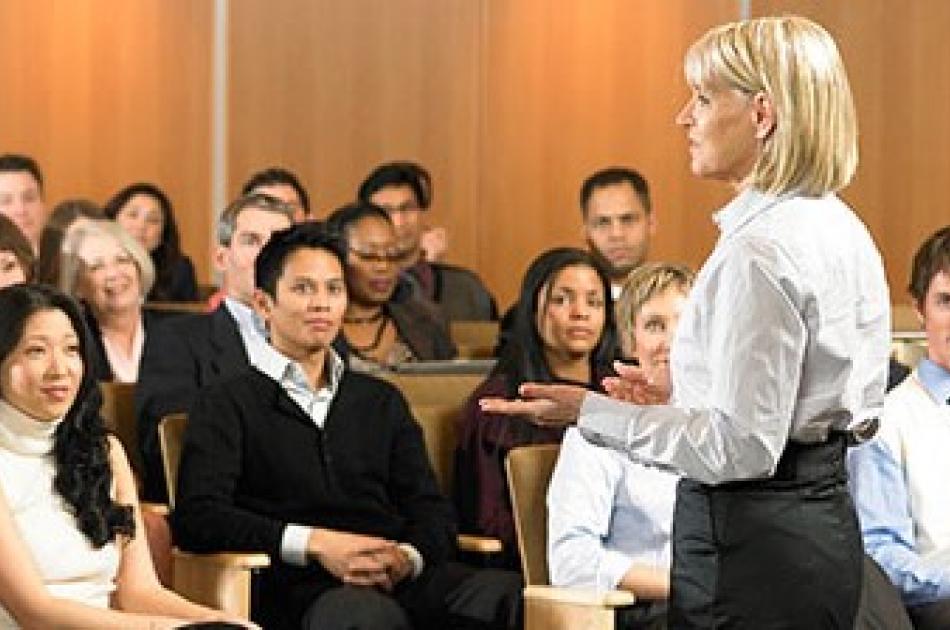 February Info Sessions Woman in white shirt lecturing in front of students