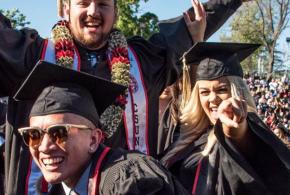 Three smiling CSUN students on their graduation day.