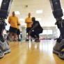 View of the prosthetic legs with people cheering in front