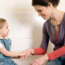 Female and toddler girl facing and smiling at each other