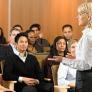 February Info Sessions Woman in white shirt lecturing in front of students